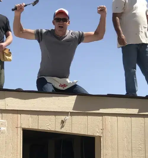 man on roof of a building at Colorado Ace Hardware