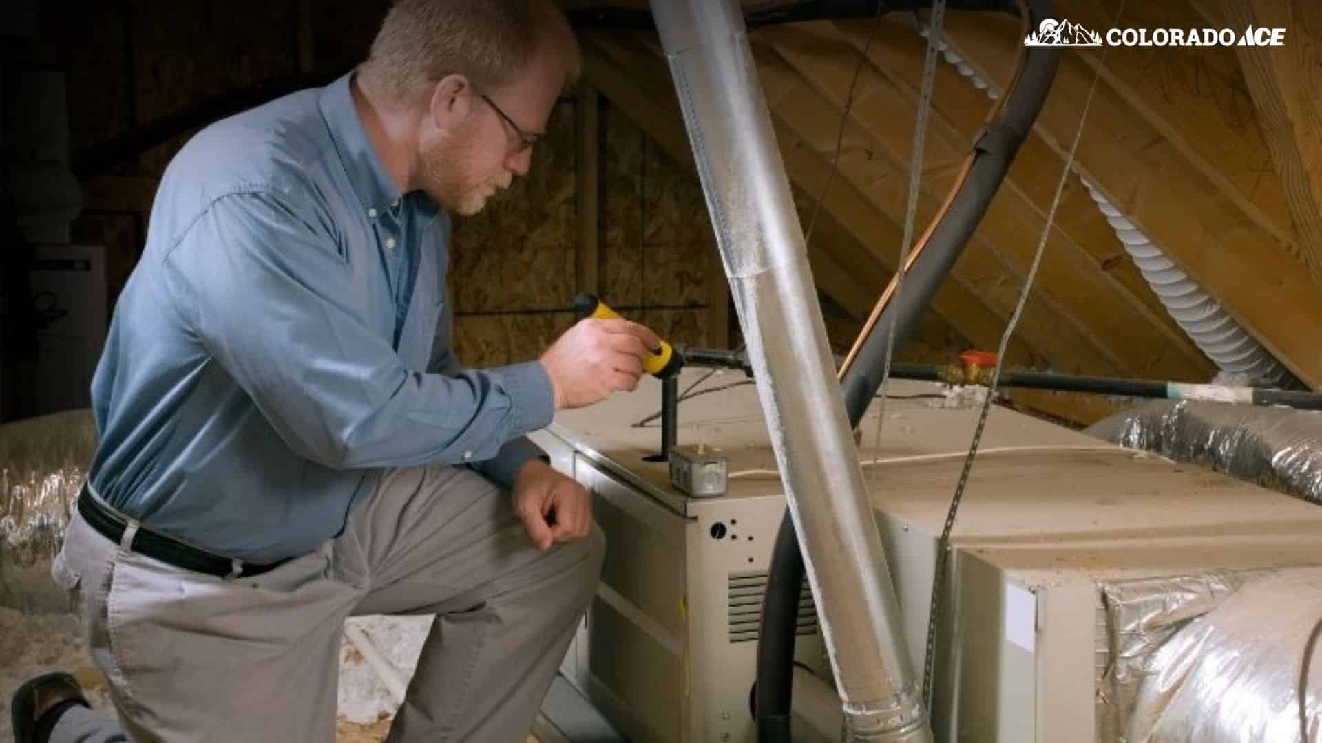 Technician performing HVAC maintenance as part of year-end facility checklist in Colorado