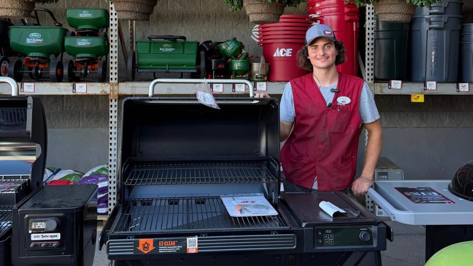 Golden – Owen: Owen from Colorado Ace Golden standing beside a large outdoor grill in the grilling department.