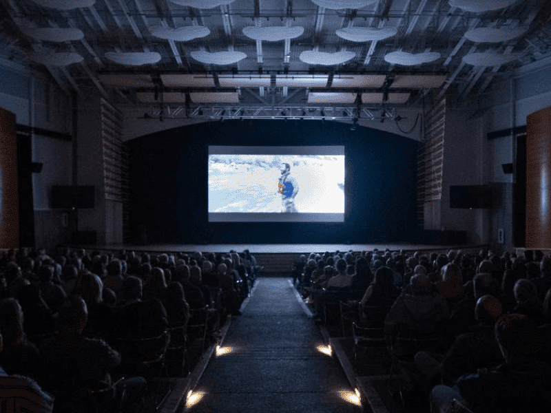 Audience seated inside the Riverwalk Center in Breckenridge watching a film during the Five Dollar Film Series event in Summit County, Colorado.