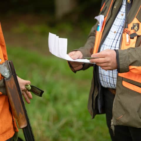 Two men checking their hunting license before going on a hunt