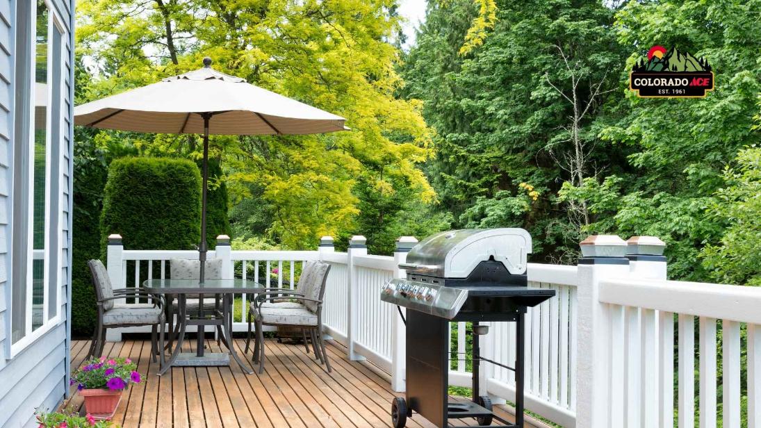 Outdoor living patio setup with grill, umbrella seating area, and backyard deck for summer entertaining in Colorado