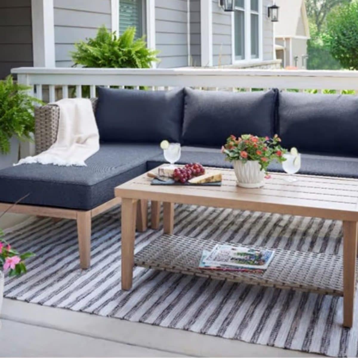 Outdoor sectional patio furniture with cushions and coffee table on backyard deck