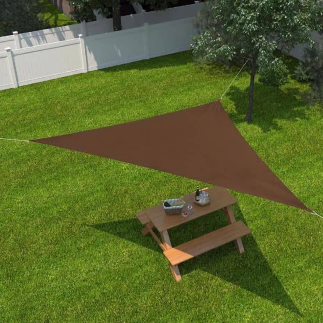 Triangle shade sail canopy installed over backyard picnic area for sun protection