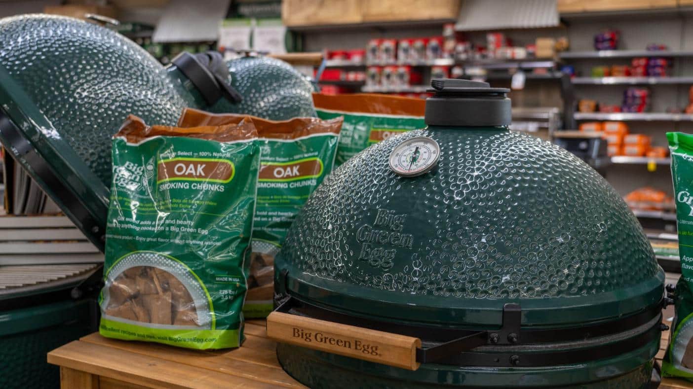 Big Green Egg ceramic grill display with smoking wood chunks inside Colorado Ace Green Mountain.