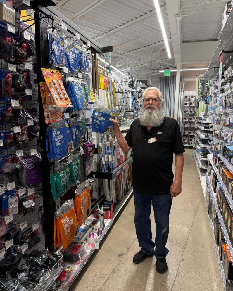 Colorado Ace team member holding foam window seal in the weatherization aisle