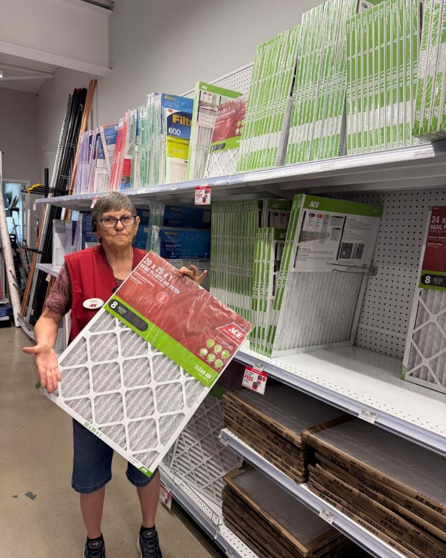 Colorado Ace team member holding a furnace air filter in the store