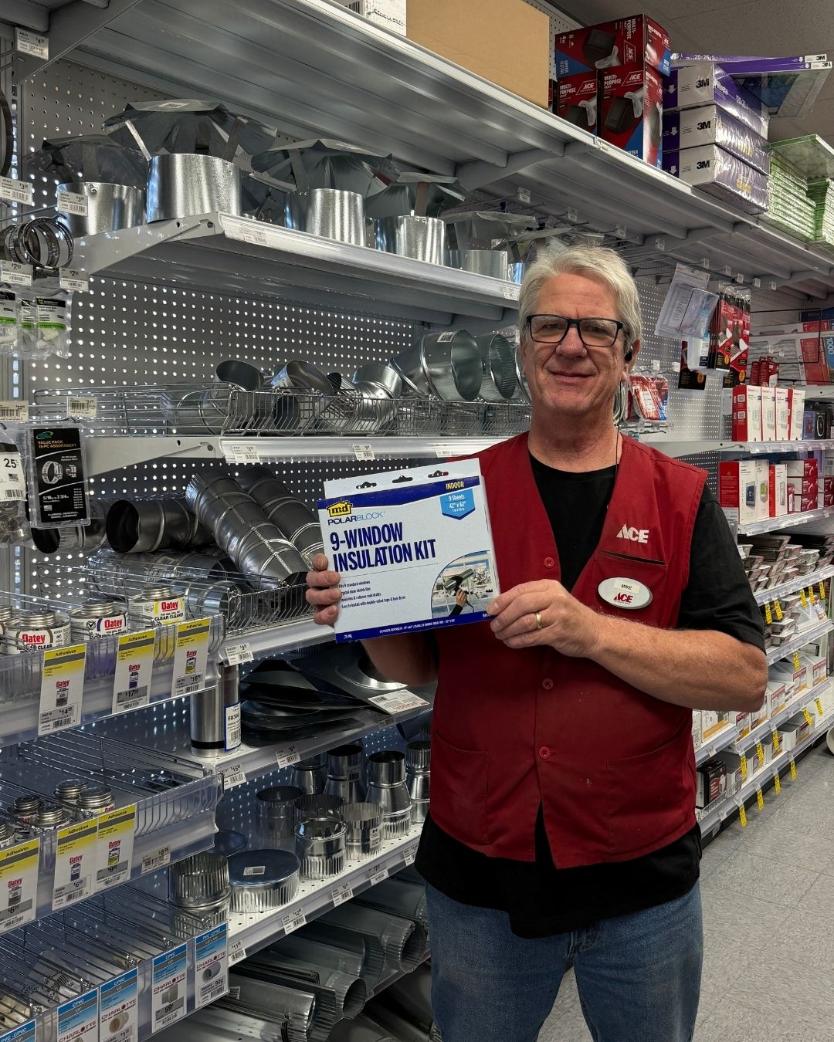 Colorado Ace team member holding a window insulation kit for winter weatherization