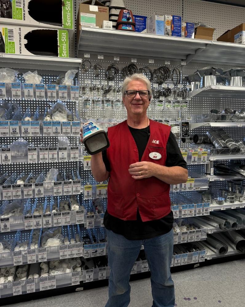 Colorado Ace team member holding an outdoor faucet cover for winter freeze protection