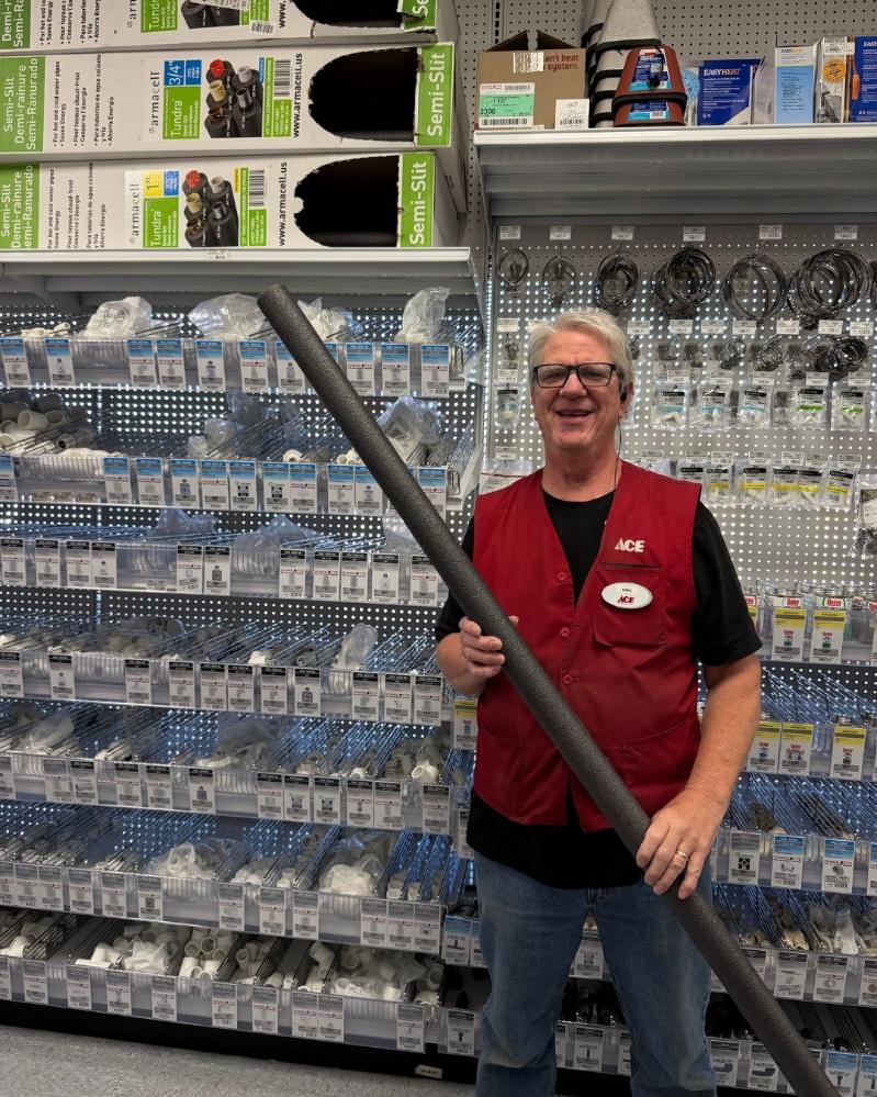Colorado Ace team member holding foam pipe insulation for winter pipe protection